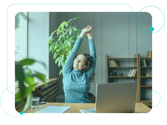 Employee stretching at her desk